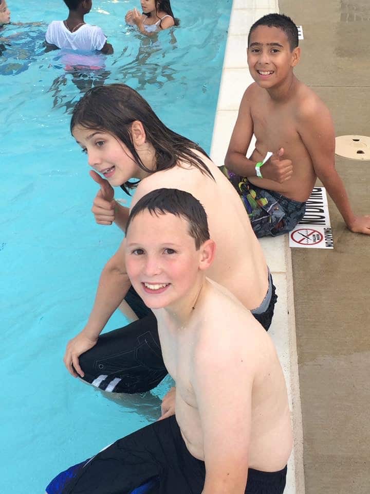 kids swimming by the pool